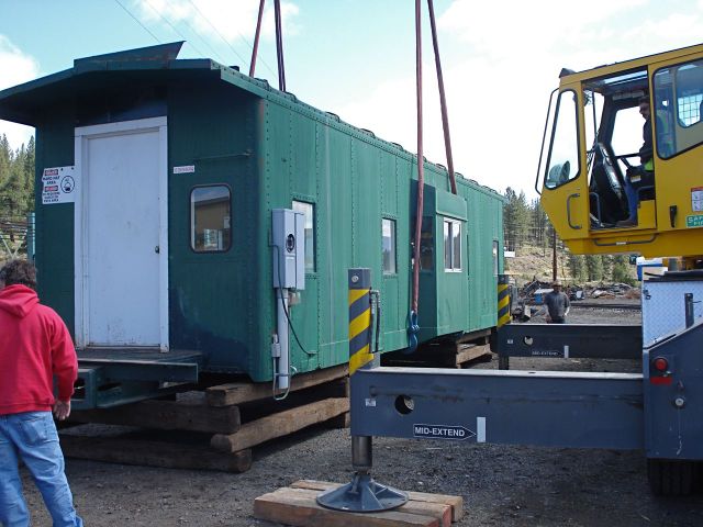 Crane lifting caboose