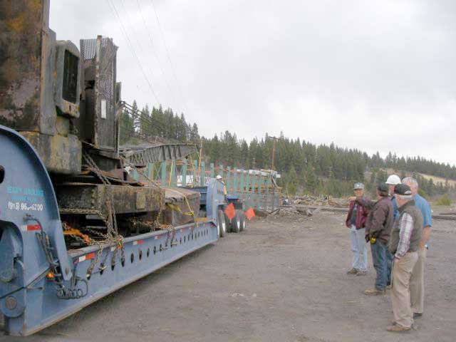 truck backing in to position to dump the crane